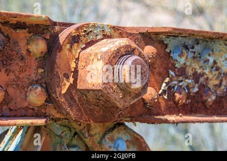 Side view of giant nut and bolt, very old and rusty Stock Photo
