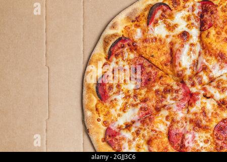 Top view of hot pizza in recycled pizza box. Stock Photo