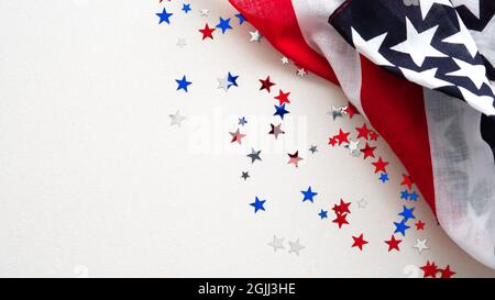 US flag and confetti stars on white background. USA Independence Day, American Labor day, Memorial Day, Columbus day banner design. Stock Photo