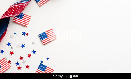 Columbus Day card, poster, background. Flat lay composition with United states decorations and ribbon on white background. Stock Photo