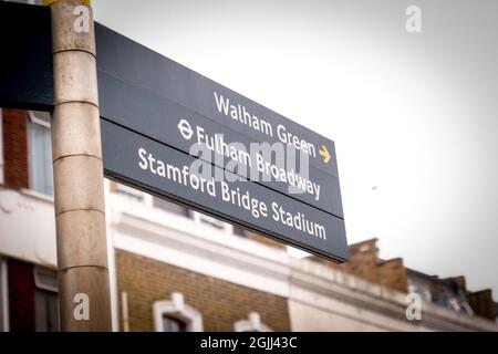 London, September 2021: Street direction sign for Walham Green, Fulham Broadway and Chelsea FC's Stamford Bridge Stadium Stock Photo