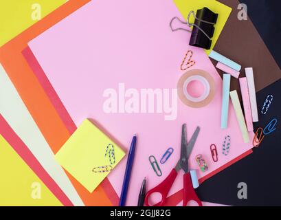 Different stationery on multicolored colorful background, flat lay with space for text. Back to school Stock Photo