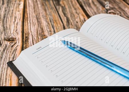 Blank pages of an open diary with a ballpoint pen for notes Stock Photo