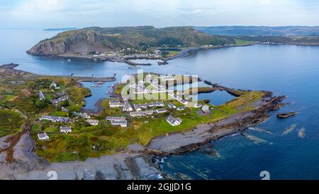 Aerial view from drone of slate islands with Easdale Island front and Ellenabeich village on Seil Island in distance, Argyll and Bute, Scotland, UK Stock Photo