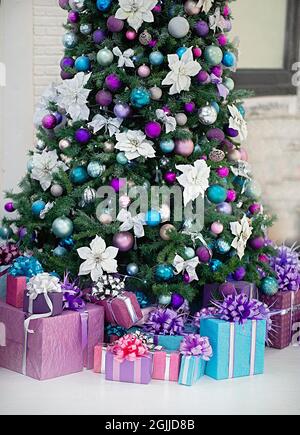 Beautiful decorated Christmas tree. Under it are gifts. The main ...