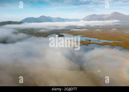 Early morning view of Rannoch Moor and A82 road  in the mist from drone, Scottish highlands, Scotland, UK Stock Photo