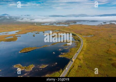 Early morning view of Rannoch Moor and A82 road  in the mist from drone, Scottish highlands, Scotland, UK Stock Photo