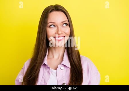 Photo of sweet brunette hairdo millennial lady look empty space wear pink shirt isolated on yellow color background Stock Photo