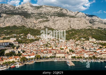 Aerial view of Makarska town below Biokovo mountain, the Adriatic Sea, Croatia Stock Photo