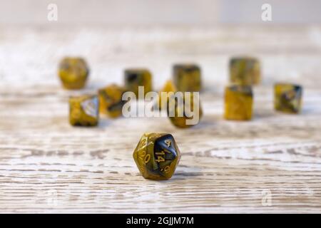 Set of dice for fantasy dnd and rpg tabletop games. Board game polyhedral dices with different sides on light wooden background Stock Photo