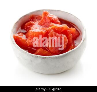 Bowl of fresh tomato sauce with tomato pieces isolated on white Stock Photo