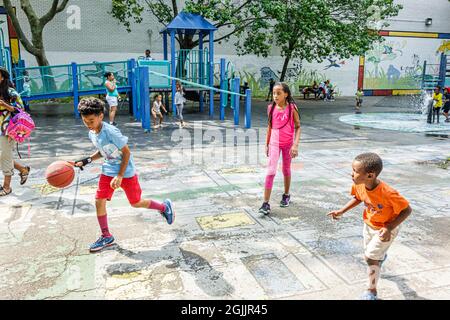 New York City,NY NYC Manhattan,Harlem,Howard Bennett Playground,Black male boys kids children girl female basketball playing friends Stock Photo