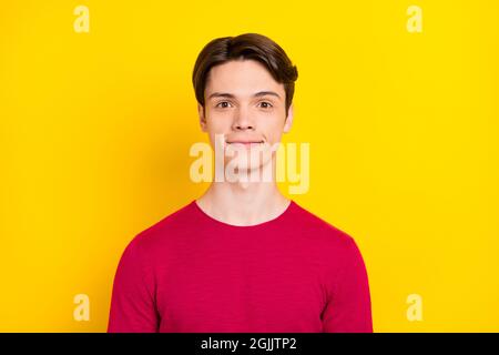 Photo of impressed pretty young guy dressed red sweater smiling isolated yellow color background Stock Photo