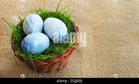 Basket with Easter eggs on a cloth. View from the top. Stock Photo