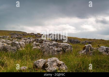 A cloudy late summer 3 shot HDR image of Limestone pavement on Orton Fell, above Orton, in Cumbria, England. 06 September 2021 Stock Photo