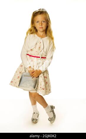 A sweet little blond girl posing for thre camera Stock Photo