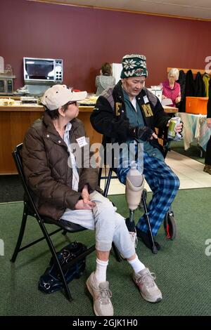 Couple at a gathering with the man disabled having an artificial leg. St Paul Minnesota MN USA Stock Photo