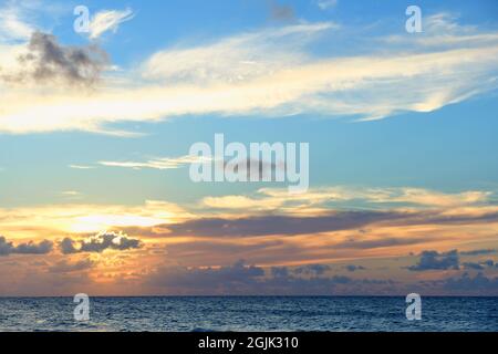 Beautiful colored cloudy evening sky. Sky with clouds at sunset. Seascape. Stock Photo
