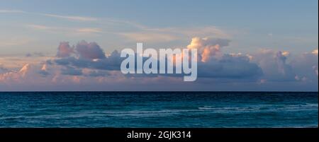 Beautiful colored cloudy evening sky. Sky with clouds at sunset. Seascape. Stock Photo