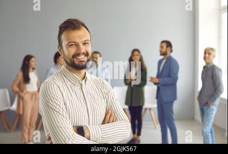 Portrait of a successful young business man who is looking at camera with confident expression. Stock Photo