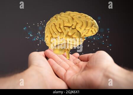 Shot of an artificial brain testing concept with additional effects over human hands Stock Photo