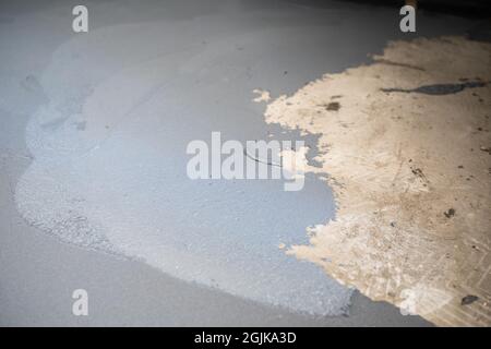 Freshly applied waterproofing mortar on the floor inside the building. Internal construction works. Stock Photo