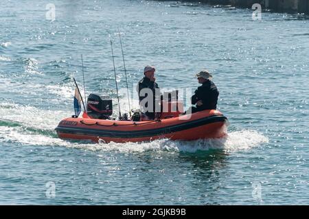 Two divers returning back to Littlehampton, Sussex, UK in a RIB inflatable boat. Stock Photo