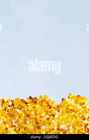 Light blue background with golden confetti, selective focus Stock Photo