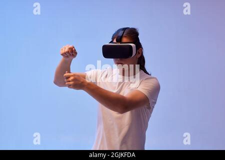 Young man using virtual reality headset. VR gadgets Stock Photo