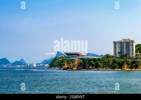 The Niteroi Contemporary Art Museum is seen from the Icarai Beach in Riod de Janeiro, Brazil. This famous place is a major tourist attraction in the c Stock Photo