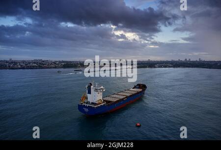Boat anchored on the outskirts of the Caribbean Sea, dances the dance of the strong waves one cloudy morning. Drone shot Stock Photo