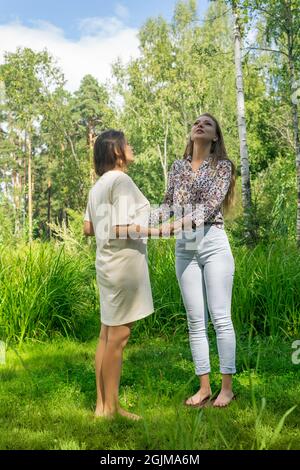 yoga coach helps a beginner to get on the sadhu board for the first time Stock Photo