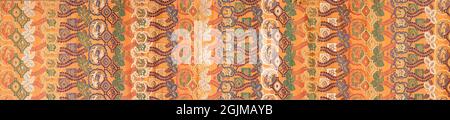 Detail of sumptuous Japanese fabric. Band of silk damask with a pattern of bands with leaf work, linked hexagons filled with flowers, lobed rectangle filled with birds and dragons and the like Stock Photo