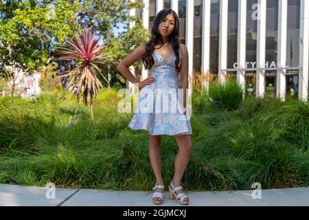Teenage Asian Girl Walking Around Park in Sweet 16 Dress Stock Photo