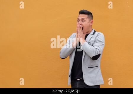 Person surprised of something nice he saw and putting his hands together. Stock Photo