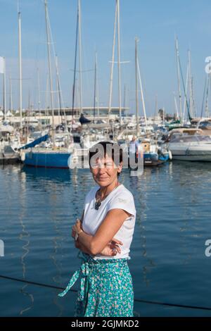 Annick Girardin is seen on the port of Cannes with sailboats in the background, during the festival.Annick Girardin (minister of the sea) inaugurated and visited the Cannes Yachting Festival. Canceled in 2020 because of the Coronavirus pandemic, it is the biggest 'boat show' in Europe. More than 560 new boats will be exhibited, of which nearly 150 will be world premieres. For the first time, a 'green' course is set up following the obligation voted by law to reserve 1% of the places in port for electric boats in French ports. Stock Photo