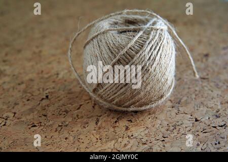 View of ball of hemp thread on brown background. Stock Photo