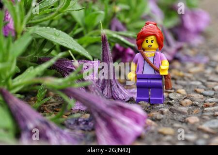 GREENVILLE, UNITED STATES - Aug 16, 2021: A closeup of a Lego minifigure of a female on the rocky ground Stock Photo