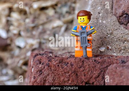 GREENVILLE, UNITED STATES - Aug 16, 2021: A closeup of a Lego minifigure construction worker on a rock Stock Photo