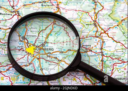 map of Nurnberg (Nuremberg) in Germany through magnifying glass, concept of planning the travel Stock Photo