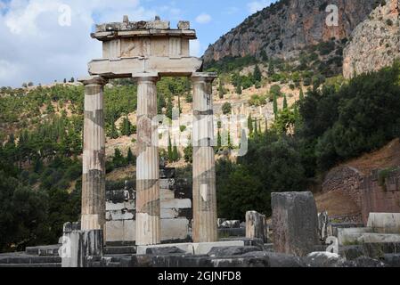 Ancient Doric order columns with the pediment, triglyph and metope at the sanctuary of Athena Pronaia the sacred archaeological site of Delphi Greece. Stock Photo