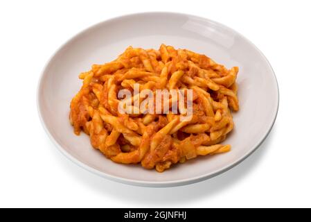 Strozzapreti macaroni pasta with tomato sauce in white plate isolated on white background Stock Photo