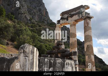 Ancient Doric order columns with the pediment, triglyph and metope at the sanctuary of Athena Pronaia the sacred archaeological site of Delphi Greece. Stock Photo