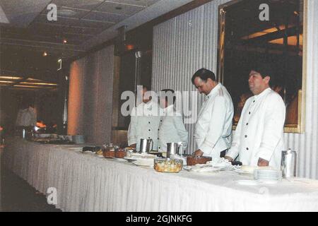 New York, USA. 9th March, 1990. Waiters on duty at a corporate dinner in the Windows on the World Restaurant on 106th Floor of the North Tower, World Trade Centre, New York. The building was destroyed 11 years later in act of terrorism on September 11th 2001. Credit: Maureen McLean/Alamy Stock Photo