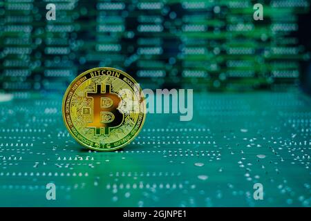 Golden bitcoin cryptocurrency new version on computer electronic circuit board background Stock Photo