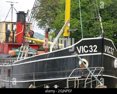 Built as a wartime supplies boat, the VC 32 was a Clyde Puffer and is now moored in the harbour at the Crinan Canal on Scotland's west coast. Stock Photo