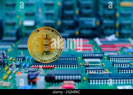 Golden bitcoin cryptocurrency new version on computer electronic circuit board background Stock Photo