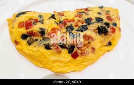 Omelet with ham and mushrooms on a white plate Stock Photo