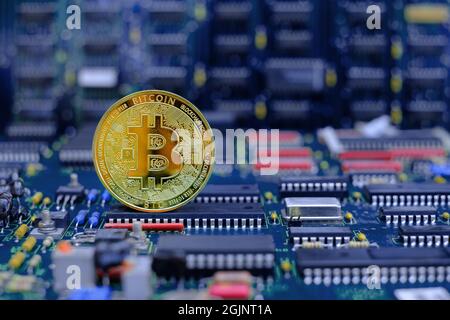 Golden bitcoin cryptocurrency new version on computer electronic circuit board background Stock Photo
