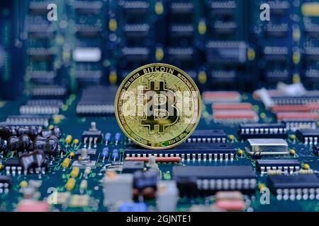 Golden bitcoin cryptocurrency new version on computer electronic circuit board background Stock Photo